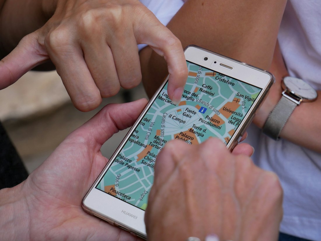 Hands zooming in on a map on a phone