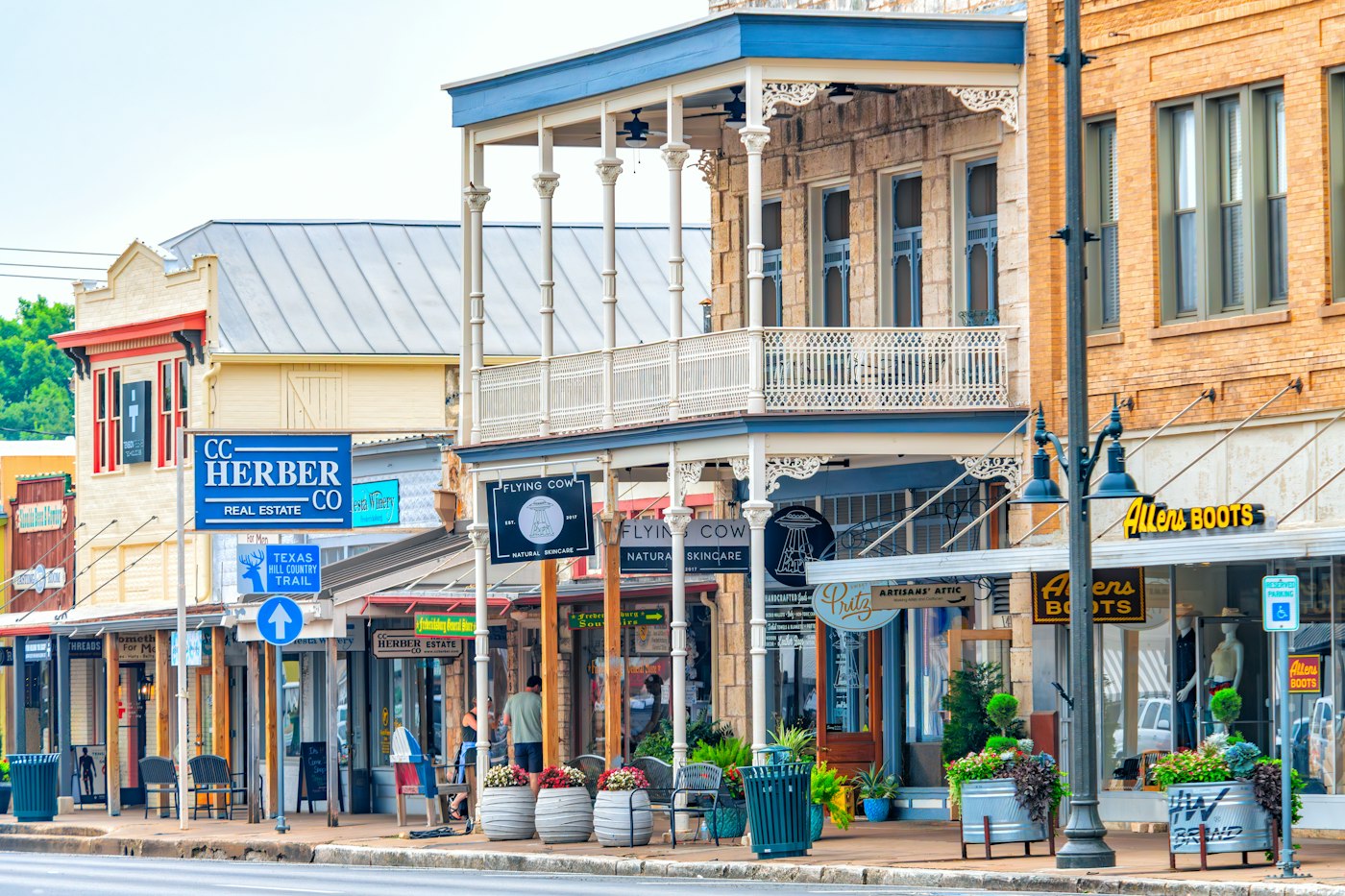 A sunny main street lined with colorful shops